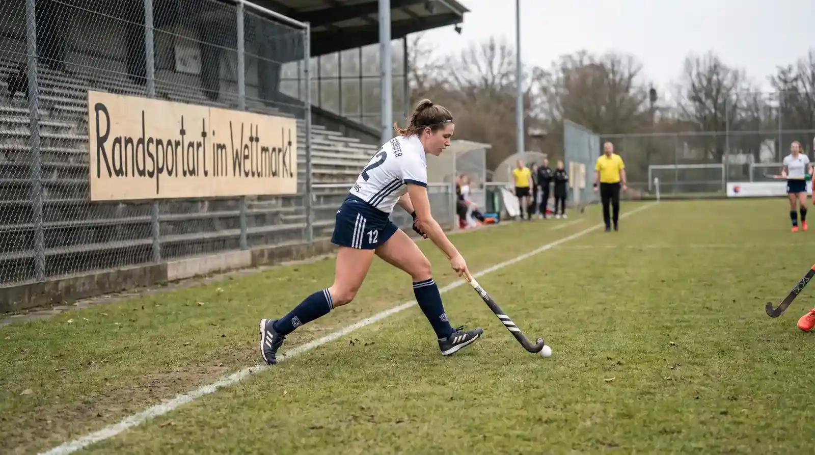 Feldhockey als Randsportart im deutschen Wettmarkt: Spieler beim Dribbling mit Schläger auf dem Rasenfeld